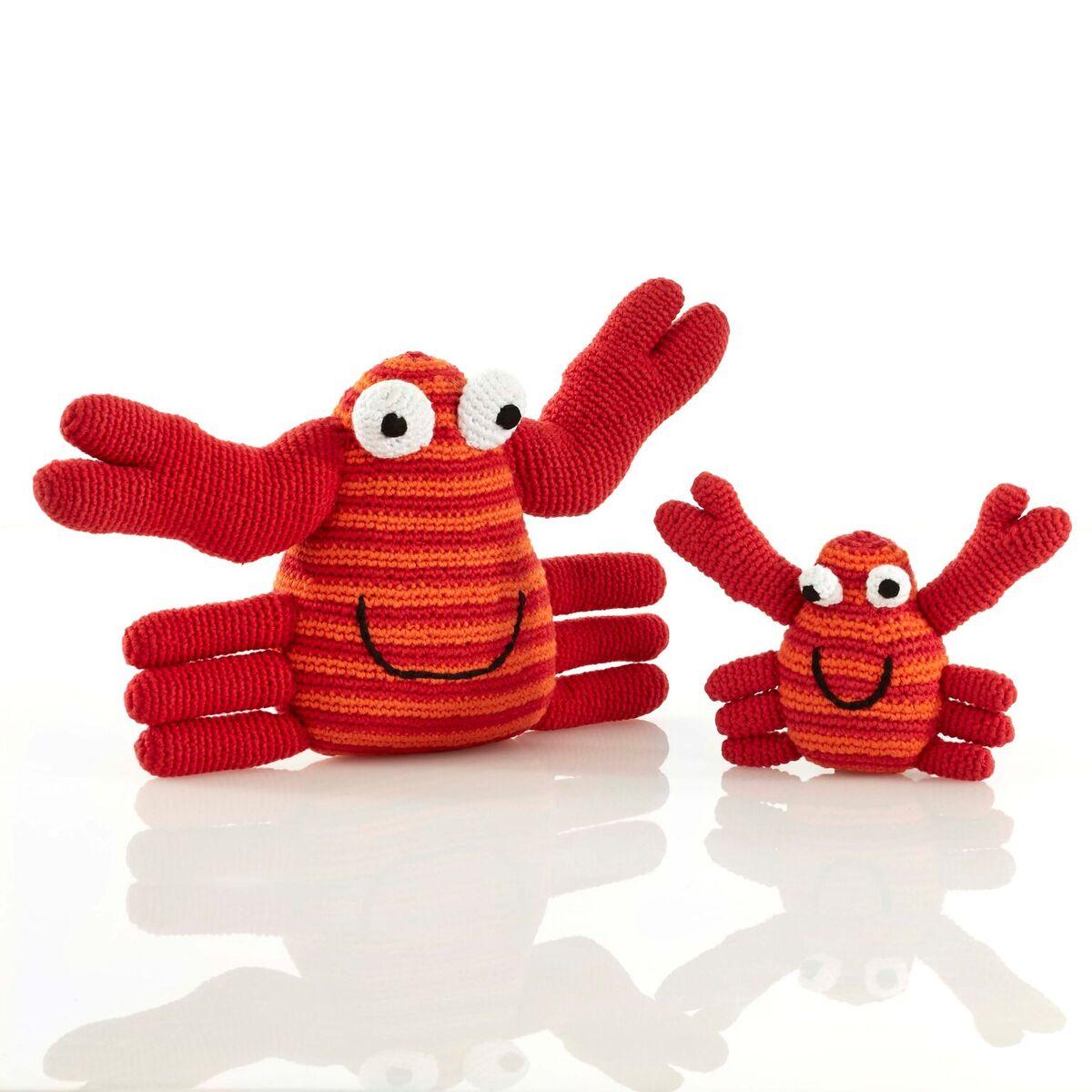 Large and small crochet crab toys with orange and red stripe bodies and red legs and pincers